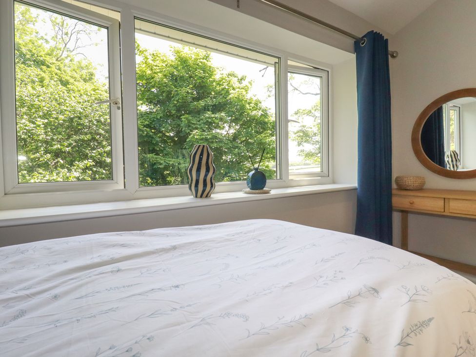A bedroom with a bed and window at 67 Manor Villas in Newquay
