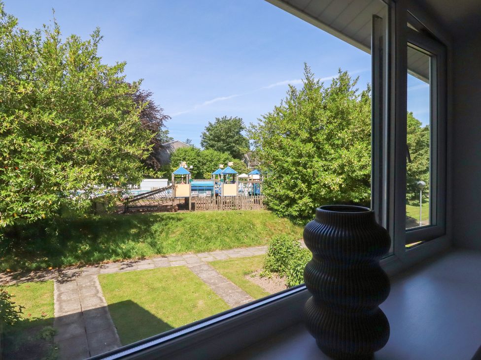 View from a window showing playground and greenery at 67 Manor Villas Newquay
