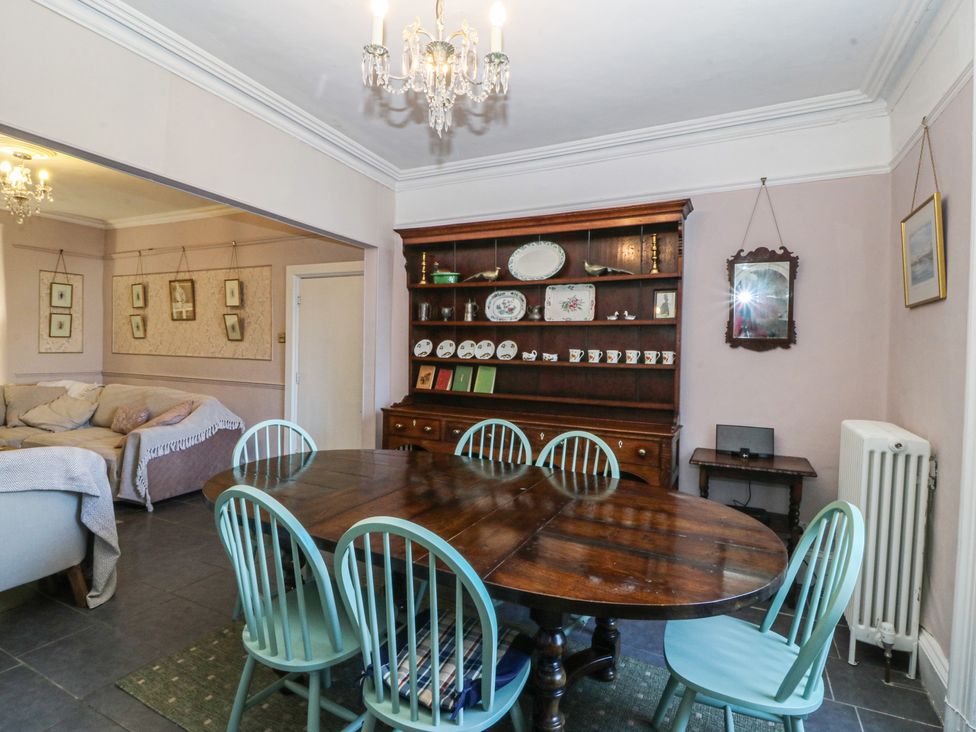 A dining room with a table and chairs at Tan y Gader in Dolgellau