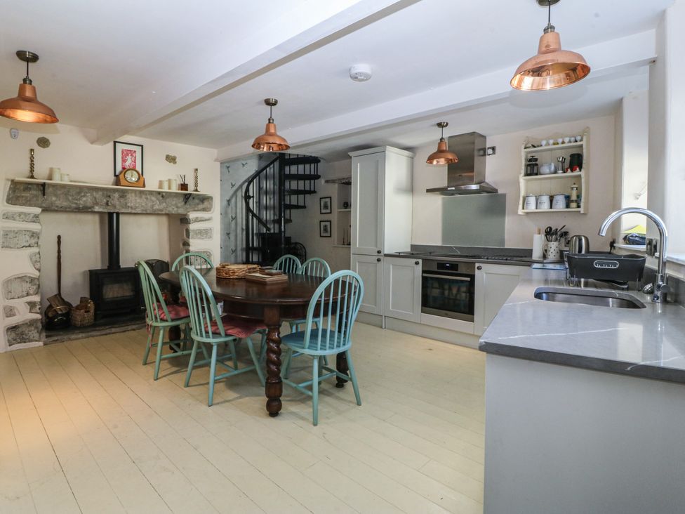 A kitchen with a table and chairs at Tan y Gader in Dolgellau