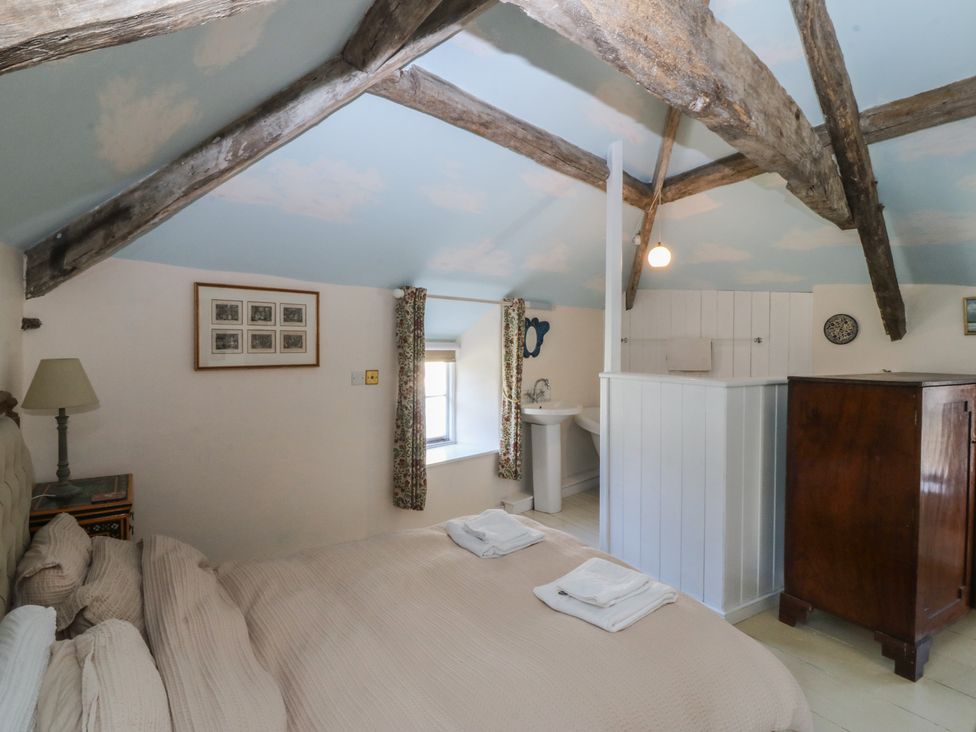 A bedroom with a bed and wardrobe at Tan y Gader in Dolgellau
