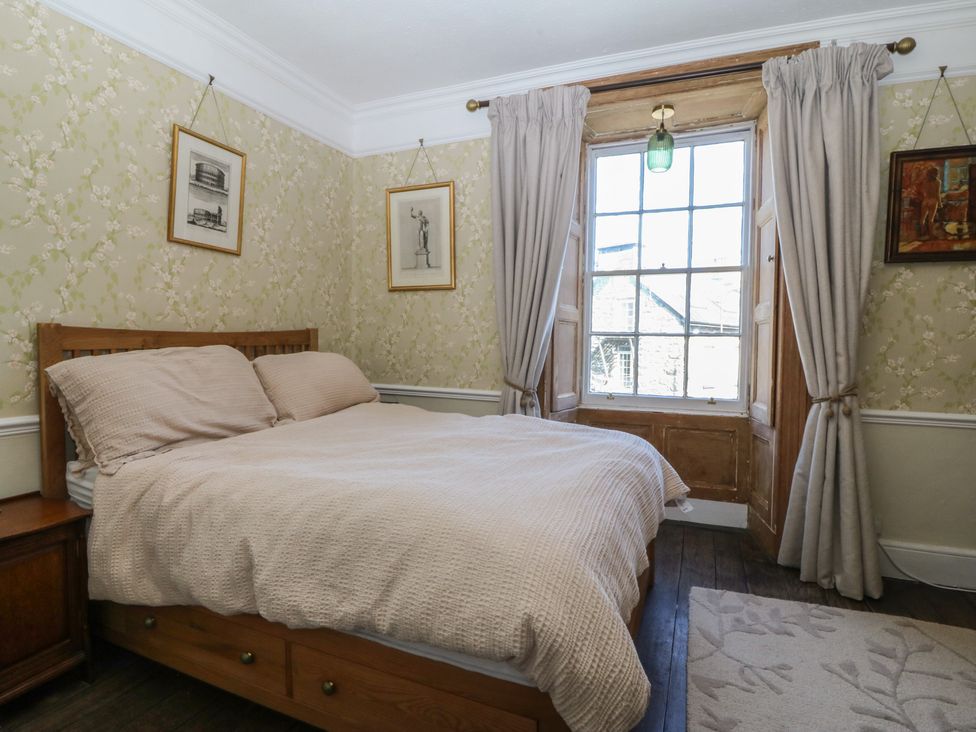 A bedroom with a bed and window at Tan y Gader Dolgellau