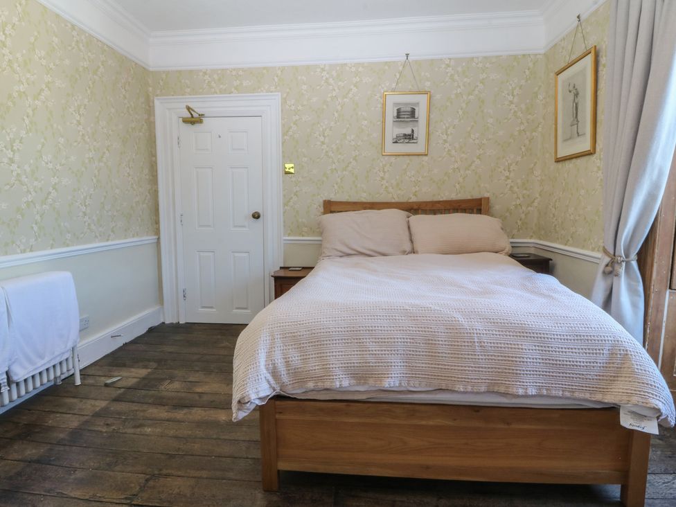 A bedroom with a bed and nightstand at Tan y Gader in Dolgellau