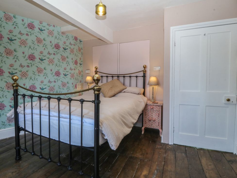 A bedroom with a bed and bedside table at Tan y Gader in Dolgellau