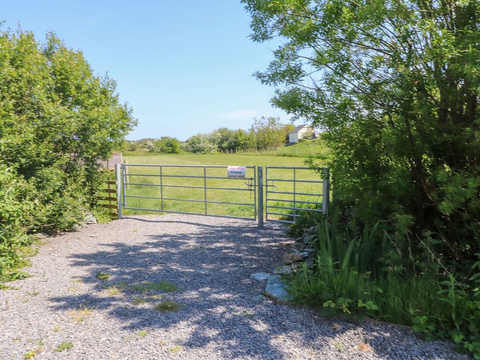 A gate leading to an open field at The Lodge in Amlwch