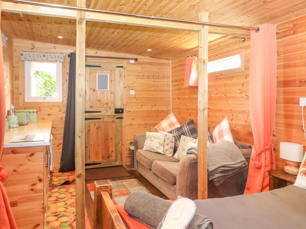 A living room with a couch and a window at The Cabin in Amlwch