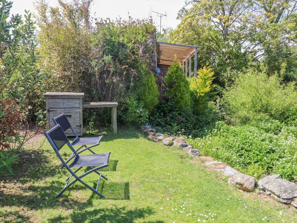 Chairs and table in a garden at The Cabin Amlwch