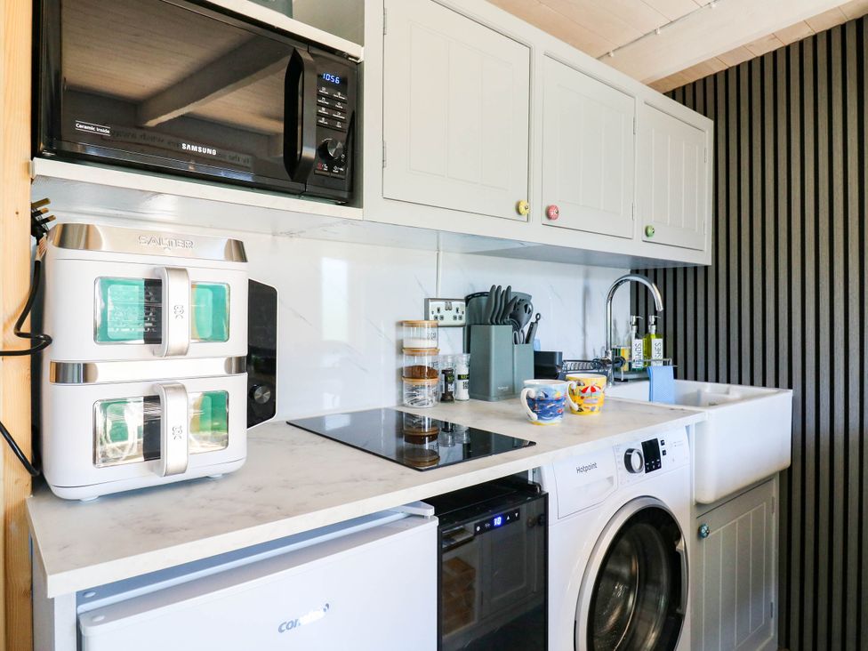 A kitchen with appliances and utensils at The Cabin in Herne Bay