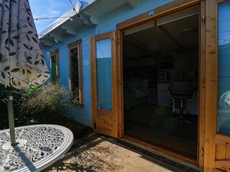 An outdoor area with a table and umbrella at The Cabin in Herne Bay