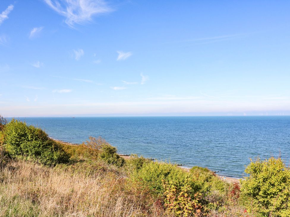 A view of the sea with plants along the shore at The Cabin in Herne Bay