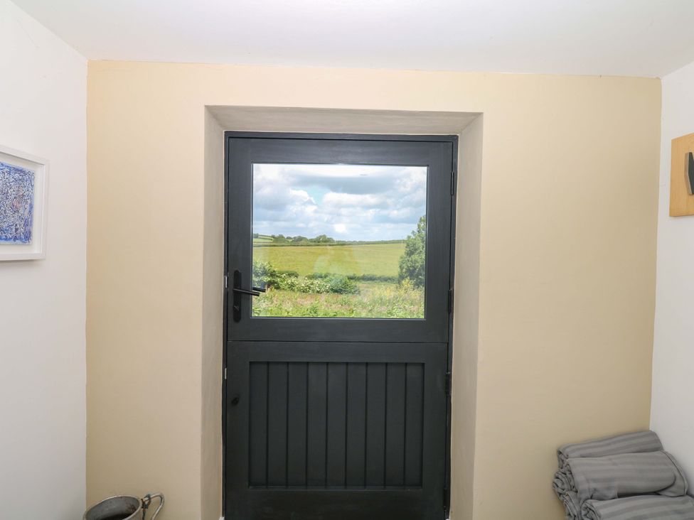 A door and window with a view of fields at Reddaway Byre Okehampton