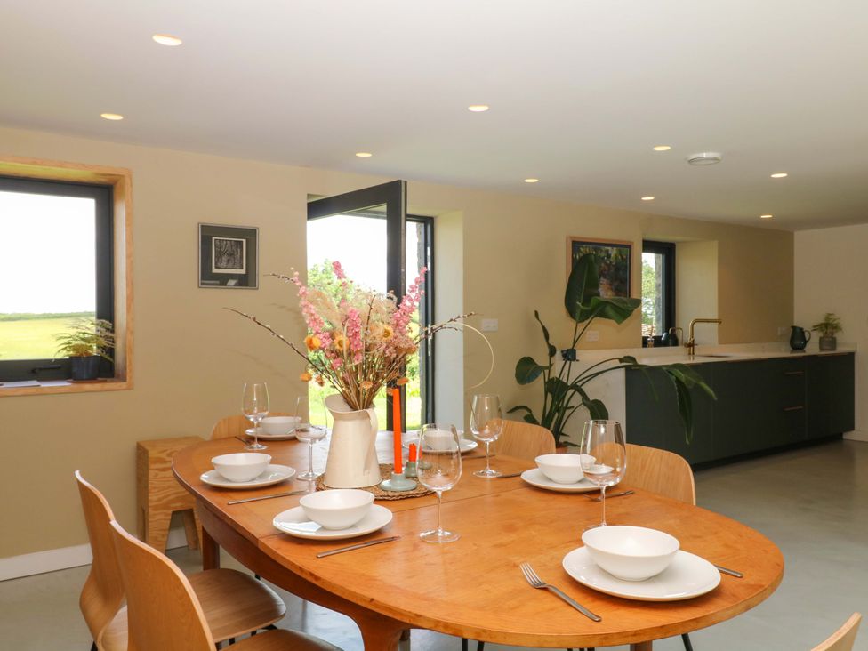 A dining room with a table set for dinner at Reddaway Byre in Okehampton