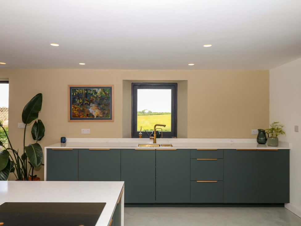A kitchen with cabinets and a sink at Reddaway Byre Okehampton