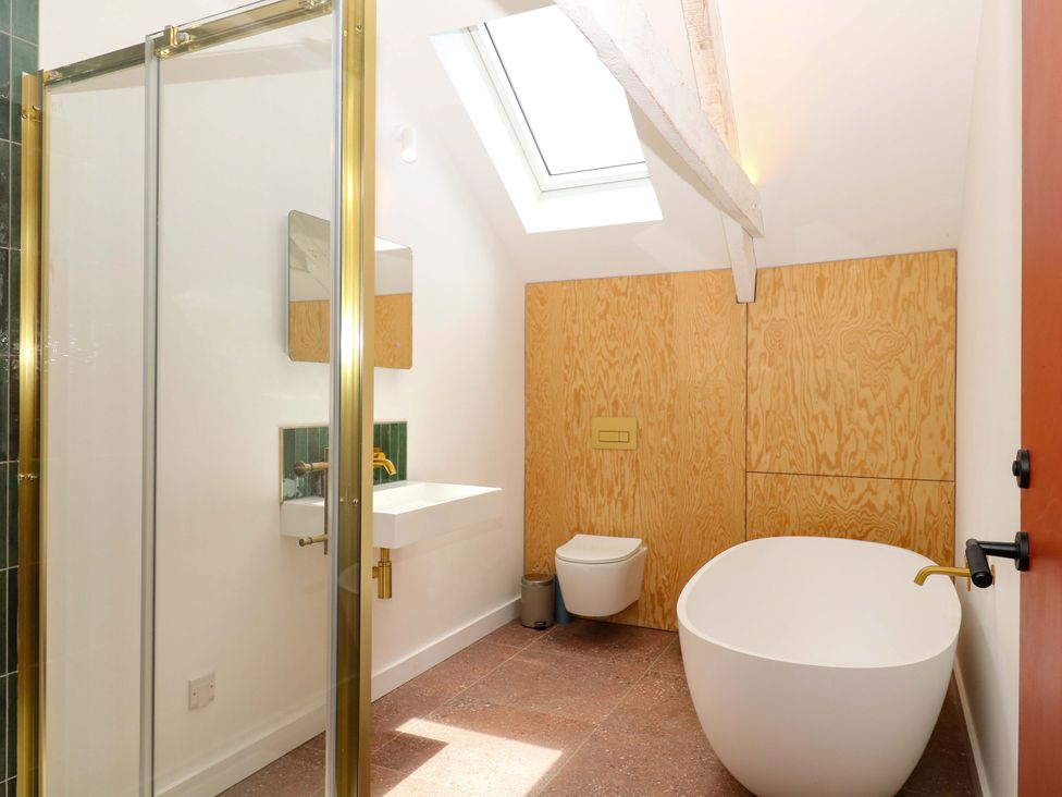 A bathroom with a shower, sink, toilet, and bathtub at Reddaway Byre in Okehampton