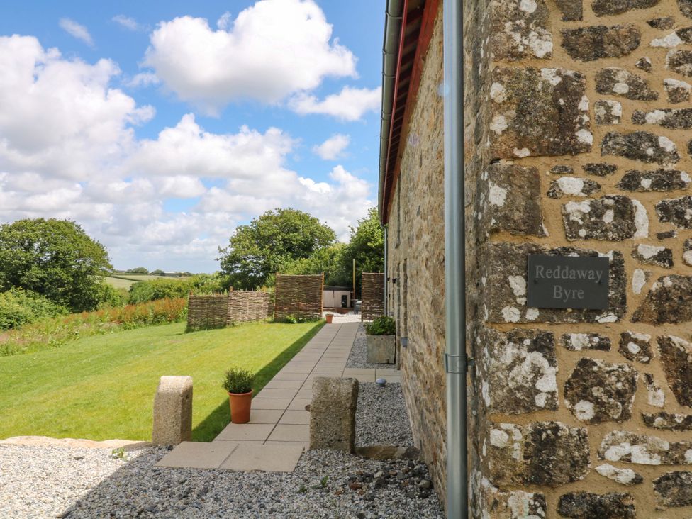 Exterior view of Reddaway Byre with pathway and grass in Okehampton