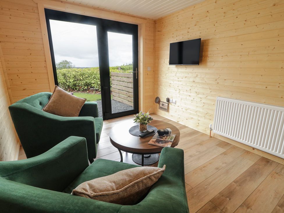 A living room with a sofa and a coffee table at Alken The Stag in Bushmills, County Antrim