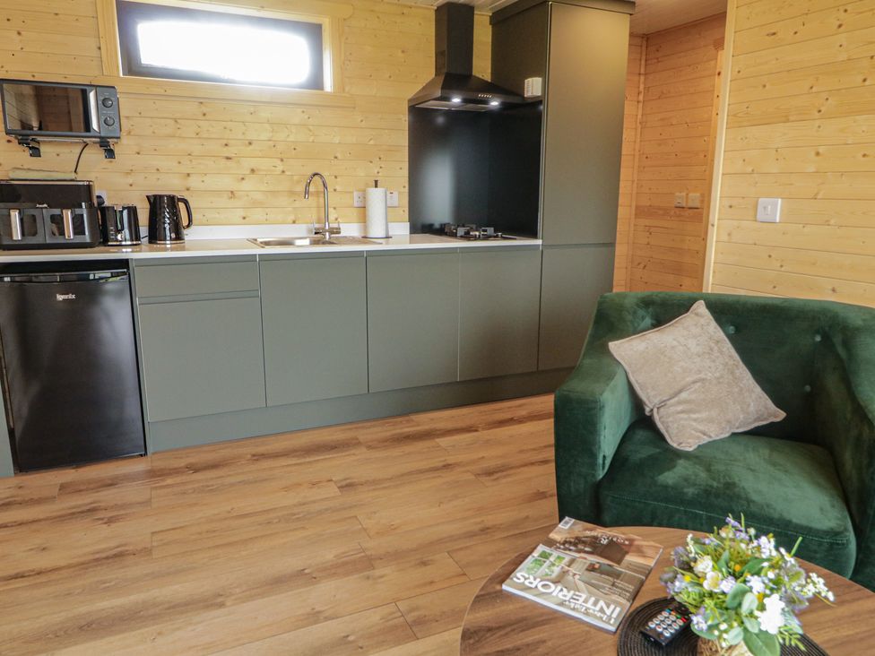 A kitchen with appliances and a sofa at Alken The Stag, Bushmills, County Antrim