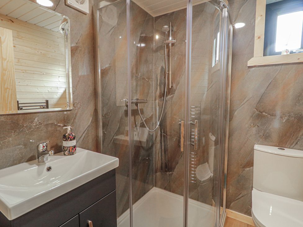 A bathroom with a shower and sink at Alken The Stag in Bushmills, County Antrim