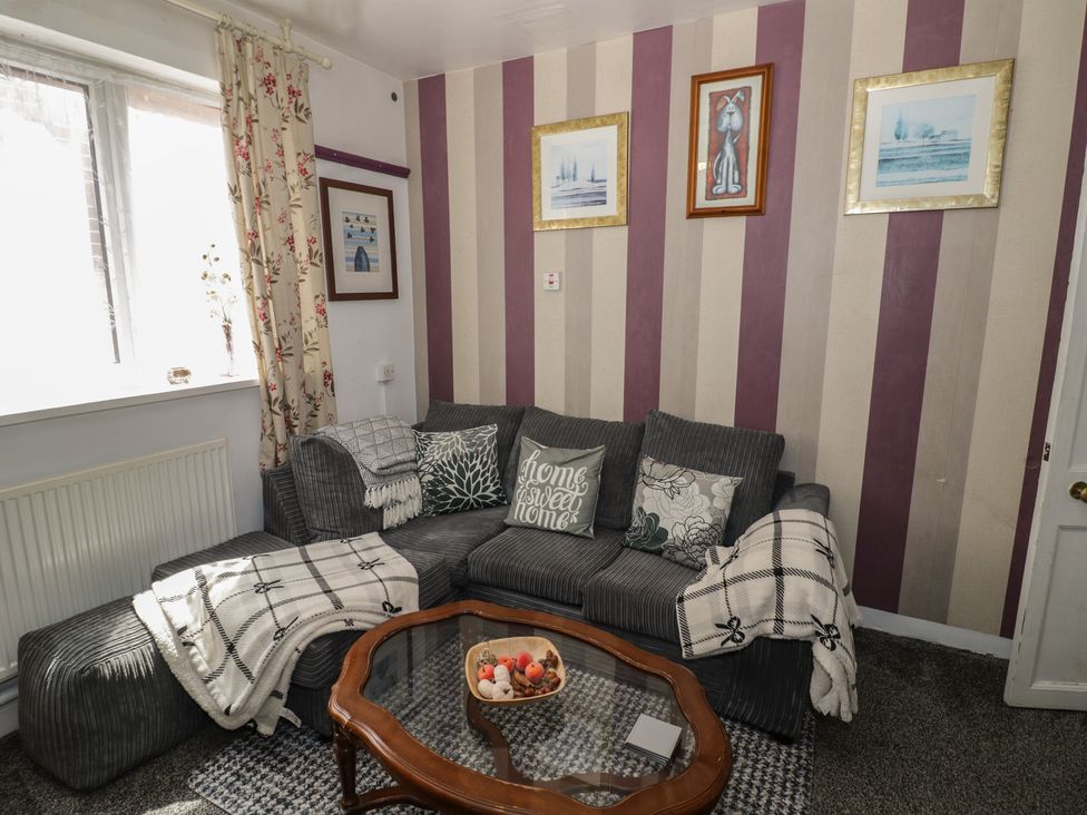 A living room with a sofa and coffee table at Mount Joy in Leicester