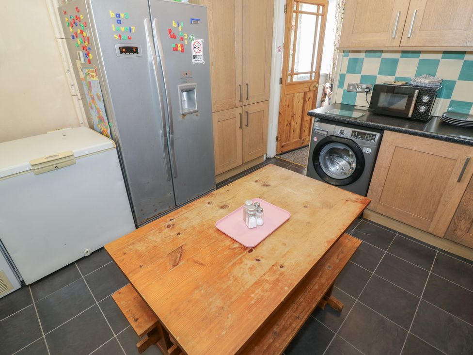 A kitchen with a table and appliances at Mount Joy in Leicester