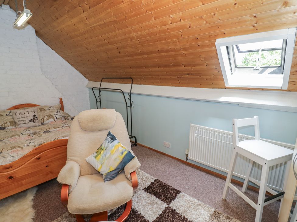 A bedroom with a bed and chair at Mount Joy in Leicester