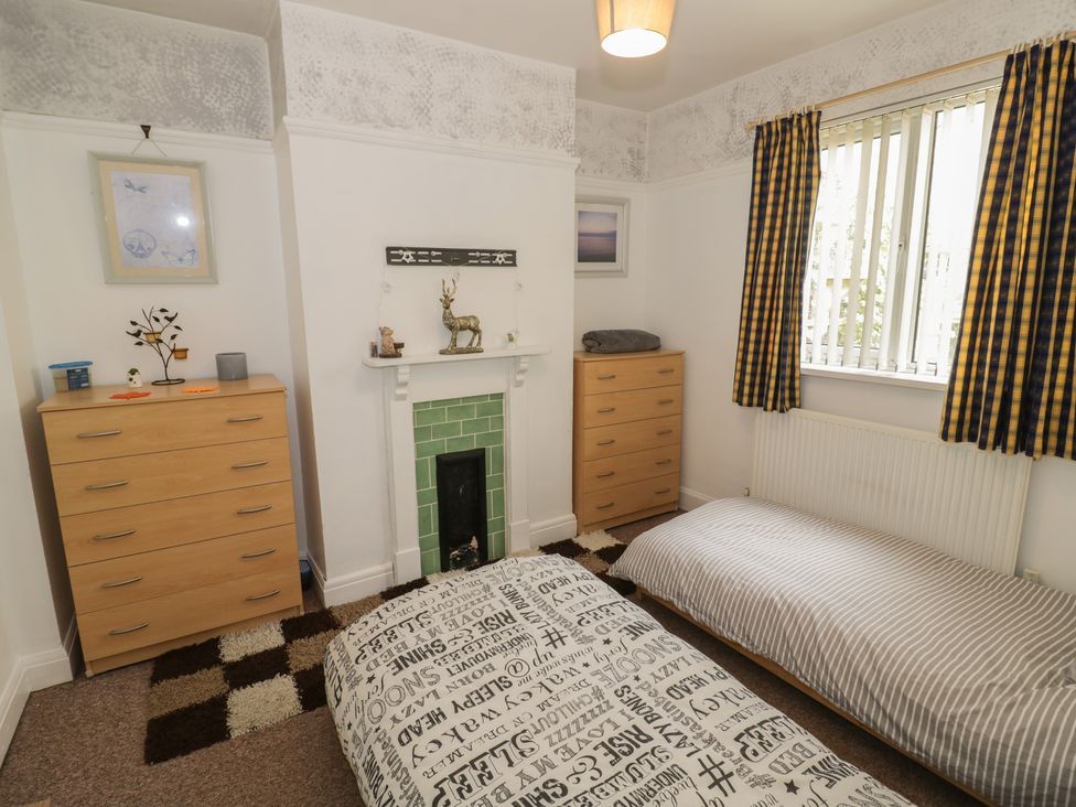 A bedroom with a bed and dresser at Mount Joy in Leicester