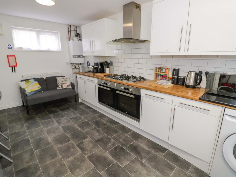 A kitchen with a stove, oven, and refrigerator at 9 Uist Walk in Corby