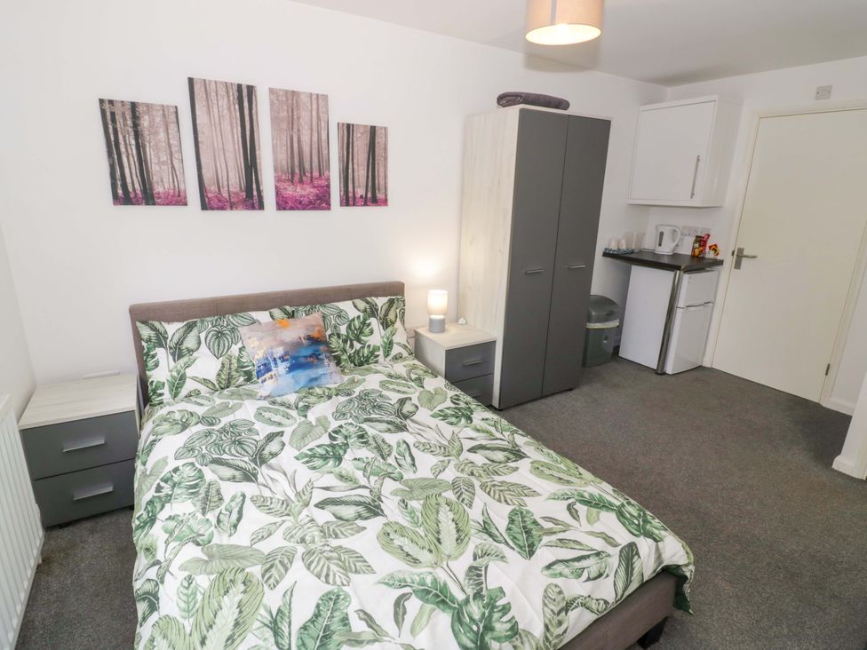 A bedroom with a bed and wardrobe at 9 Uist Walk in Corby