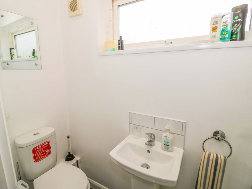 A bathroom with a toilet and sink at 9 Uist Walk in Corby