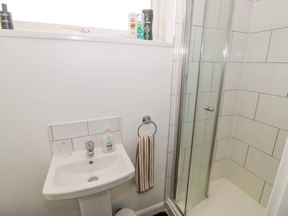 A bathroom with a sink and a shower at 9 Uist Walk Corby