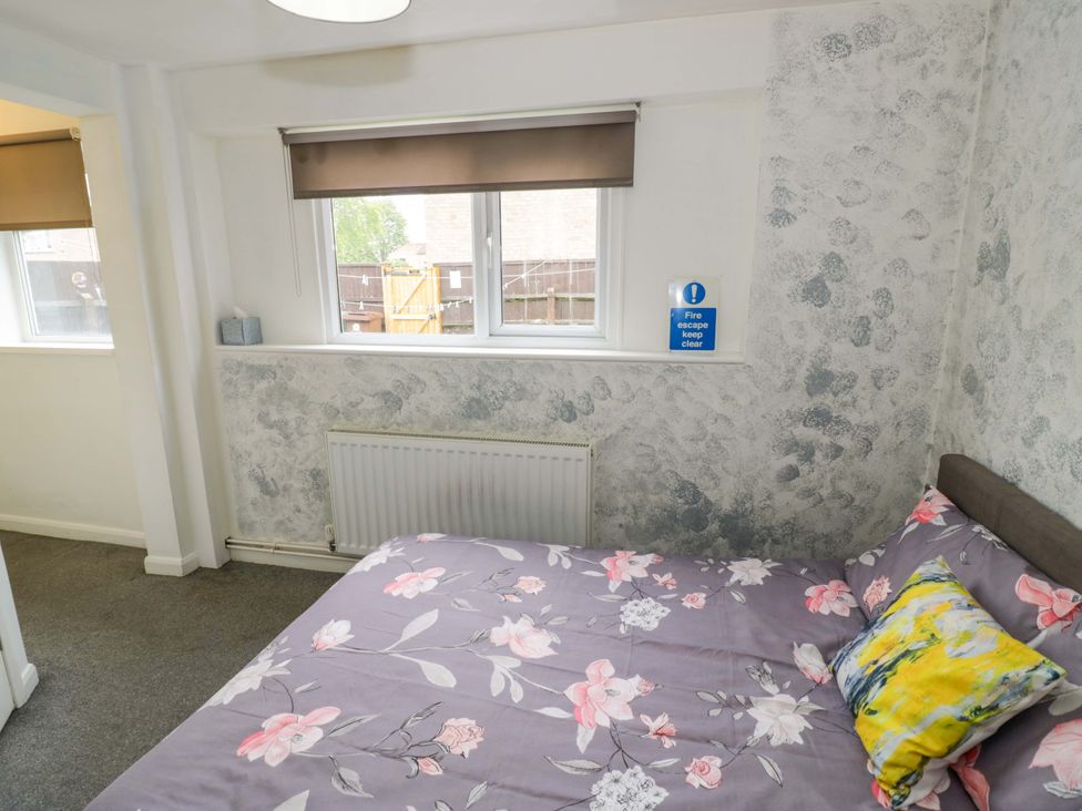 A bedroom with a bed and window at 9 Uist Walk in Corby