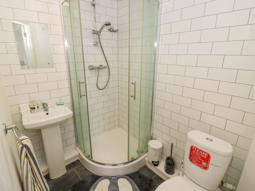 A bathroom with a shower, toilet, and sink at 9 Uist Walk in Corby
