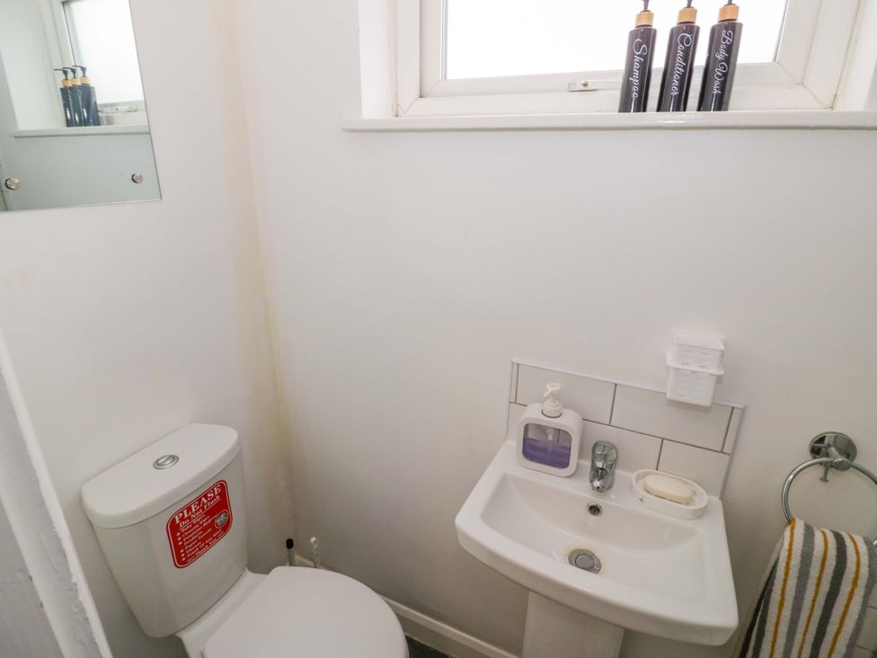 A bathroom with a toilet and sink at 9 Uist Walk in Corby