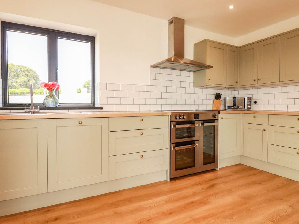 A kitchen with cabinets and appliances at The Granary in Launceston