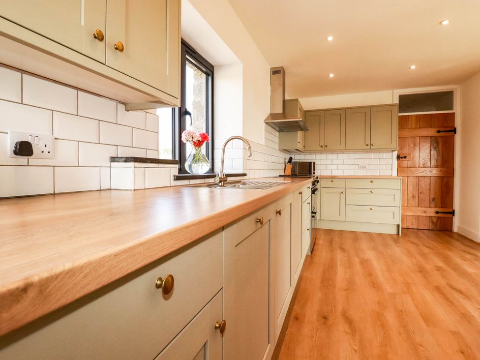 A kitchen with cabinets and a sink at The Granary in Launceston