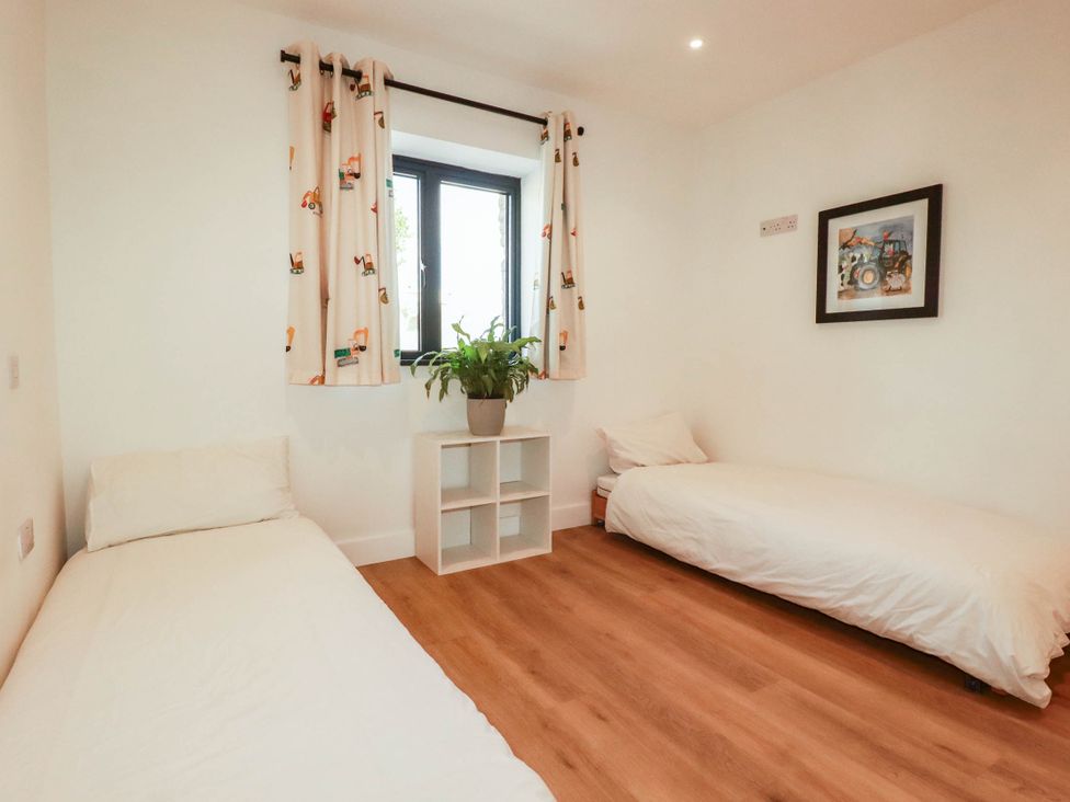 A bedroom with two single beds and a window at The Granary in Launceston
