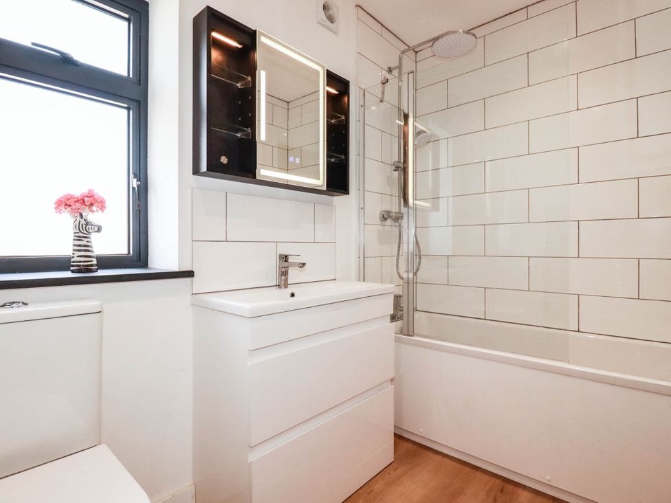 A bathroom with a toilet, sink, and shower at The Granary in Launceston