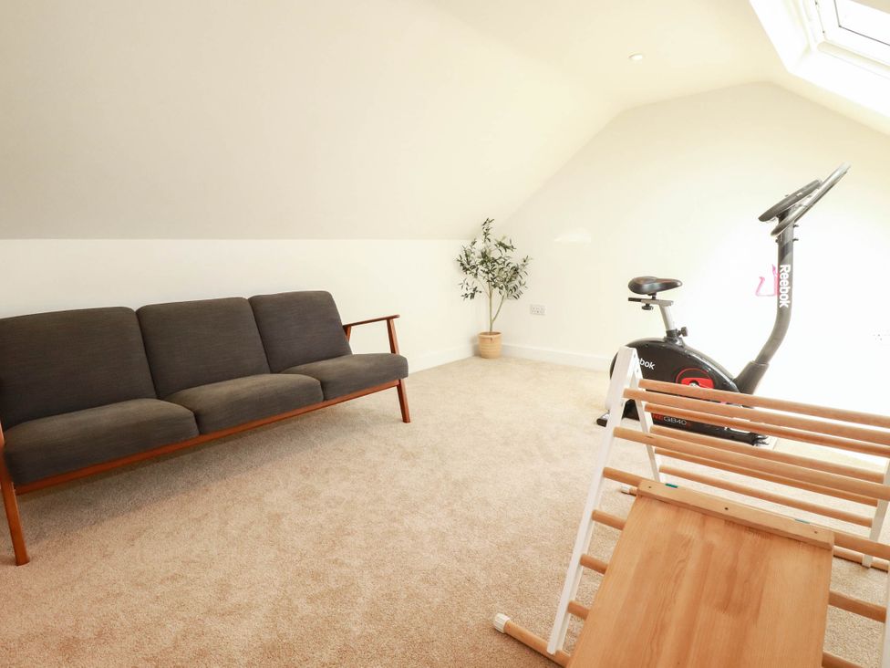 A gym with a sofa and exercise bike at The Granary in Launceston
