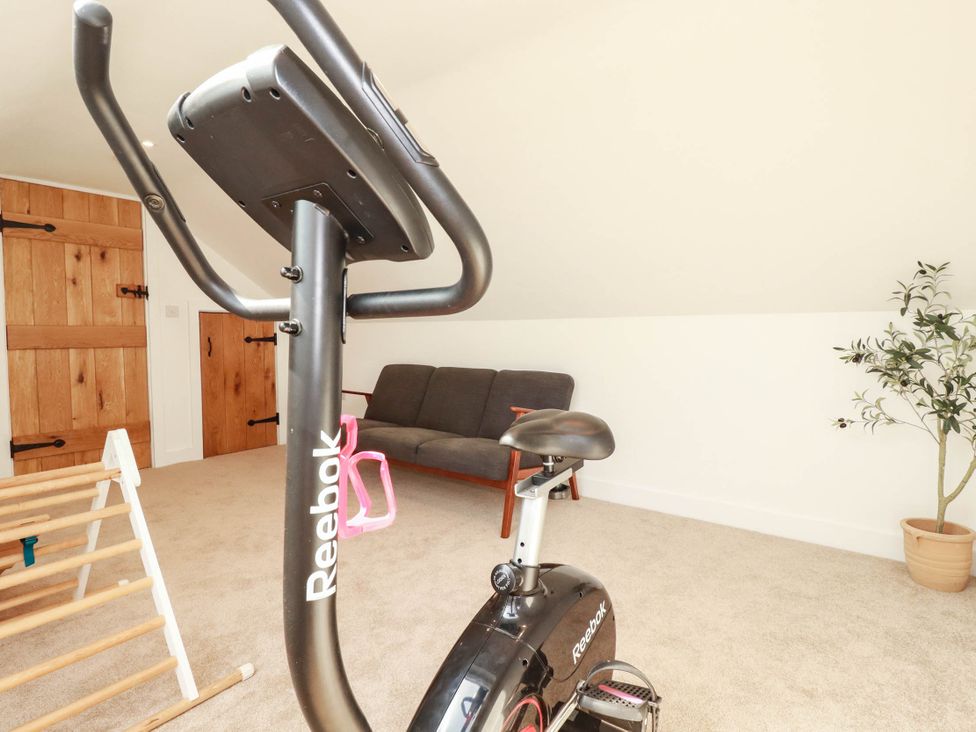 A gym with an exercise bike and a sofa at The Granary in Launceston