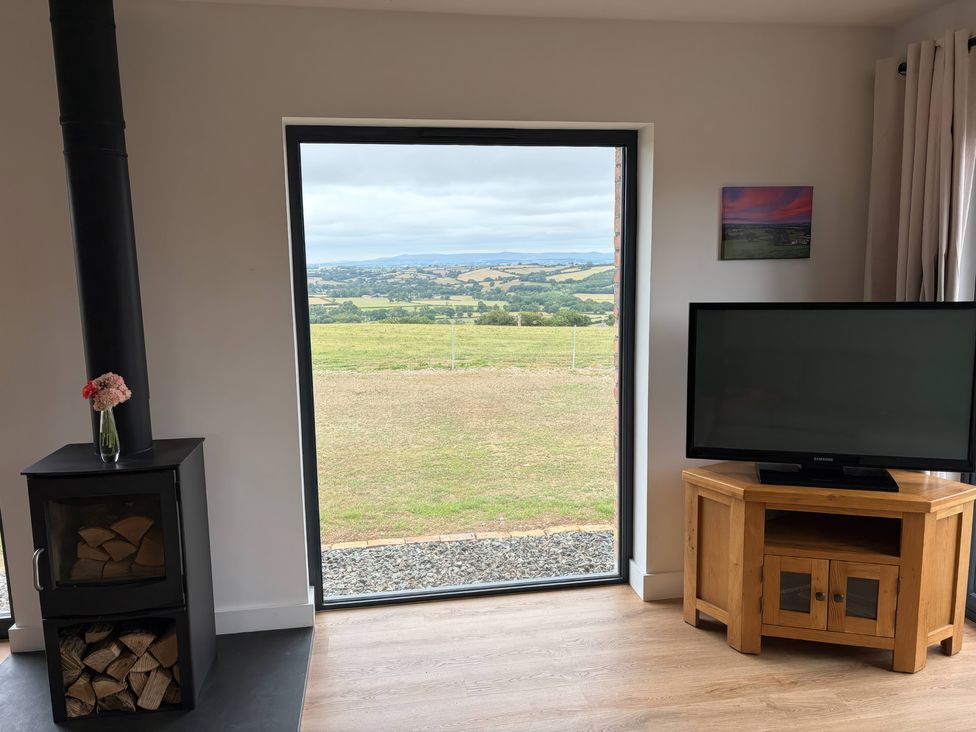 A living room with a fireplace and television at Up Top in Launceston