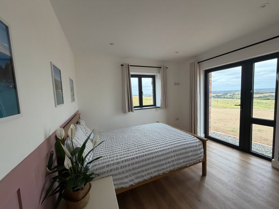 A bedroom with a bed and windows at Up Top in Launceston