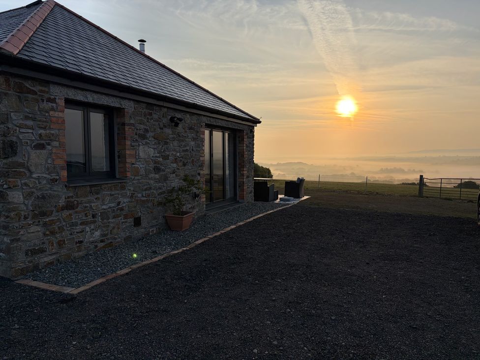 A stone building with a sunset view at Up Top in Launceston