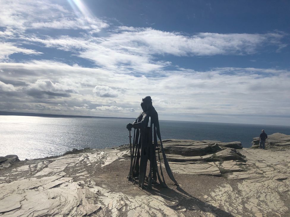 A statue overlooking the ocean on rocky terrain at Up Top in Launceston