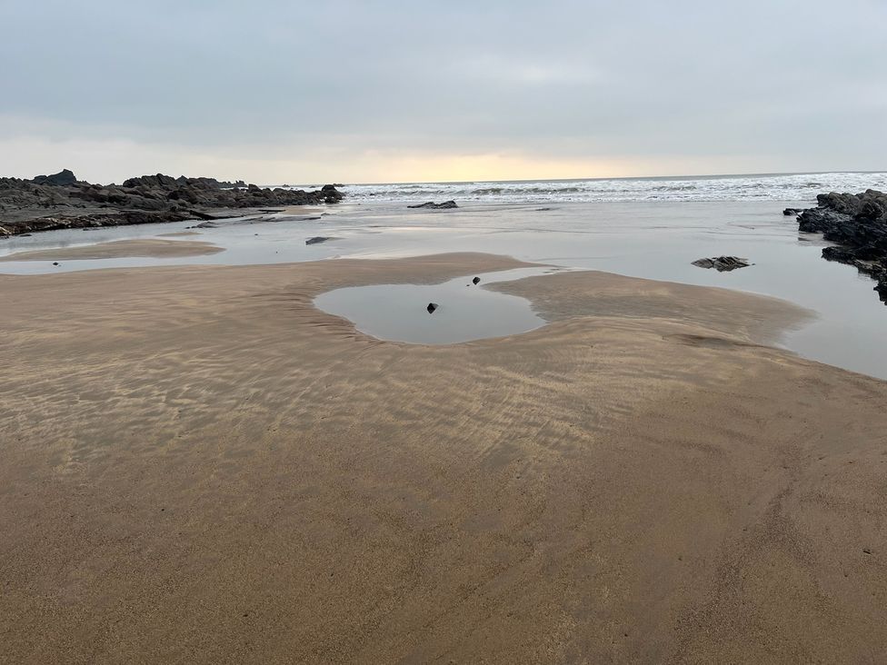 A beach with water and rocks at Up Top in Launceston