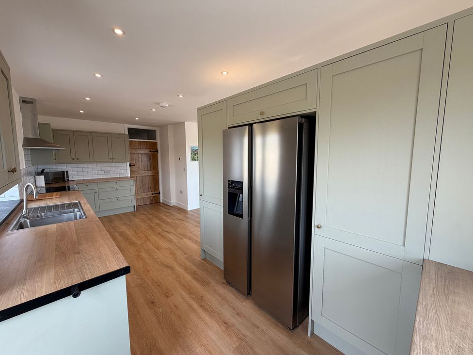 A kitchen with a refrigerator and sink at High View Barn in Launceston