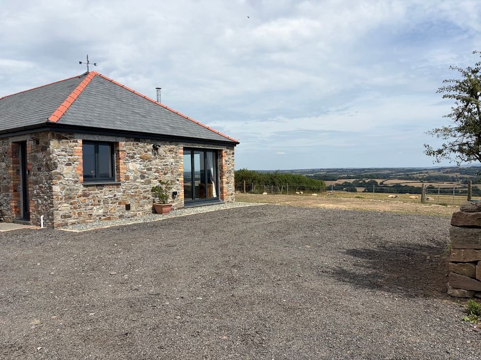 A house with a stone exterior and a gravel area at High View Barn Launceston
