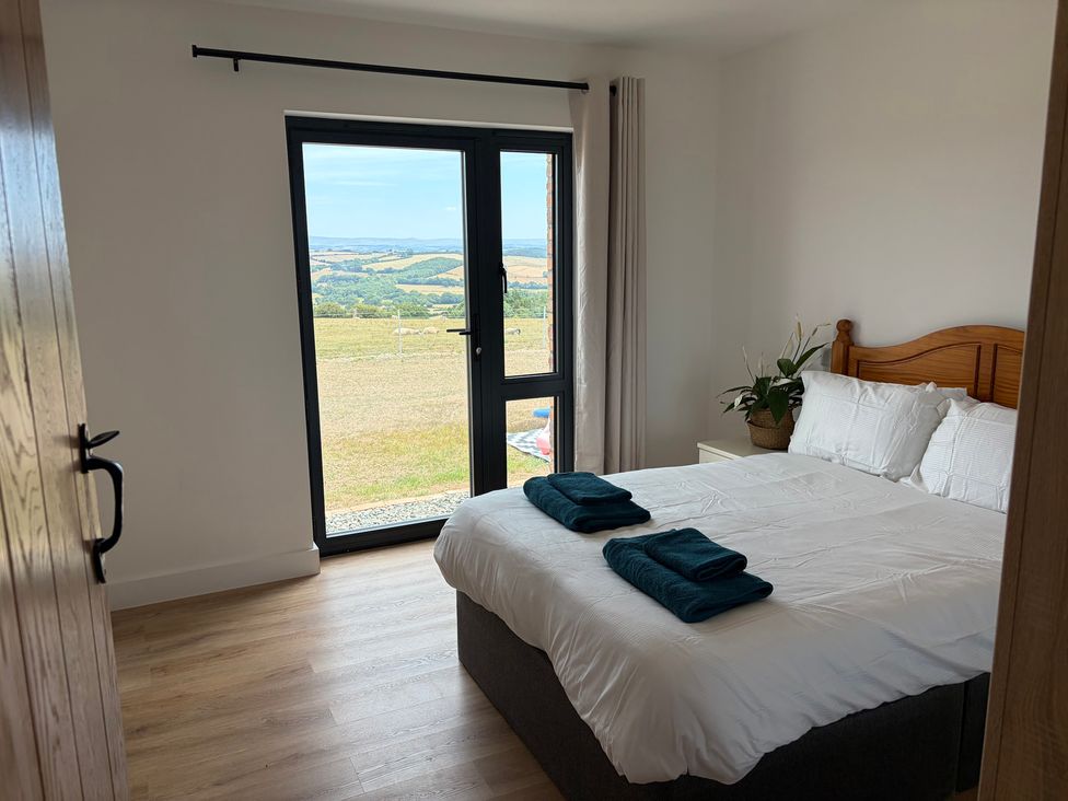 A bedroom with a bed and towels on it at High View Barn in Launceston
