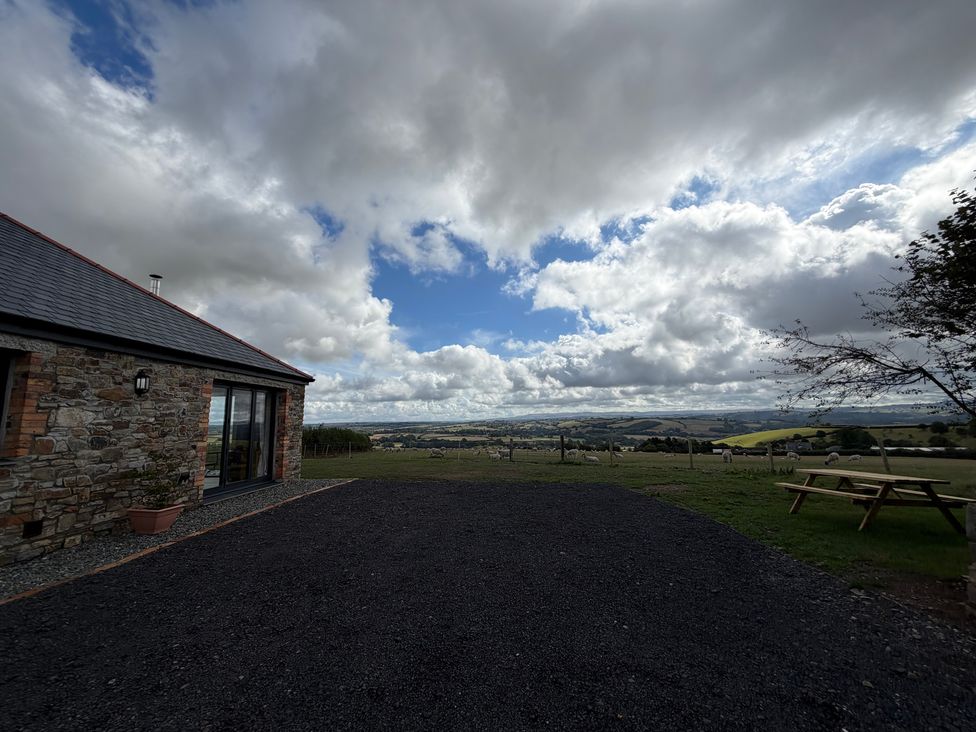 An outdoor view of a stone building with a garden at High View Barn in Launceston