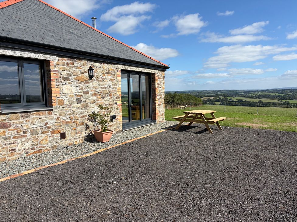 An outdoor area with a stone wall and picnic table at High View Barn in Launceston