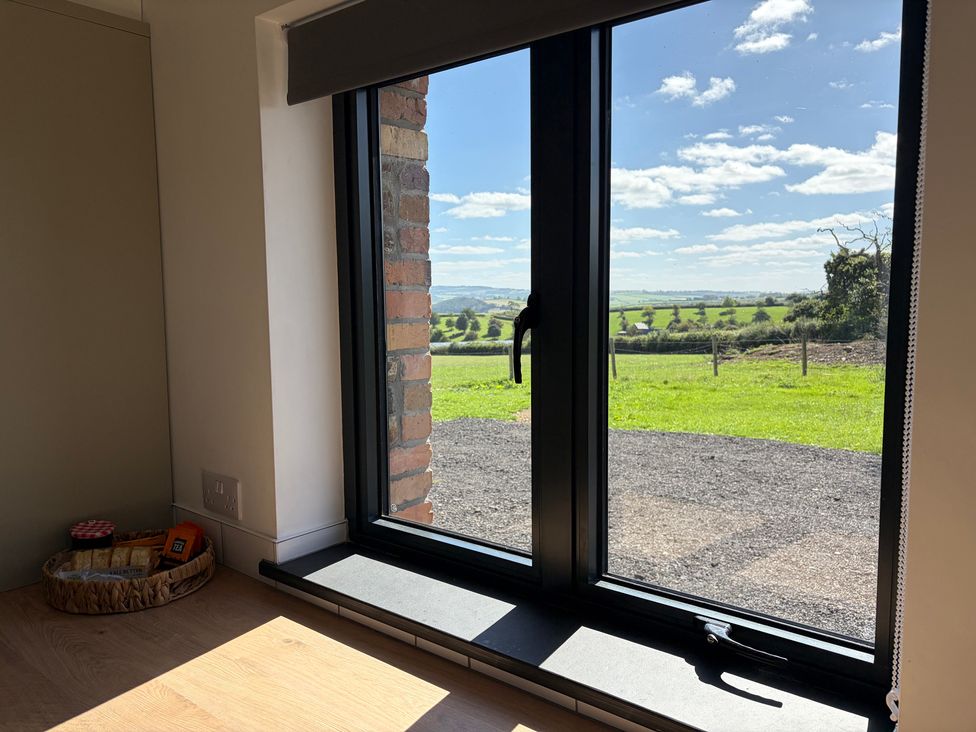 A window with a view and a basket of snacks at High View Barn Launceston